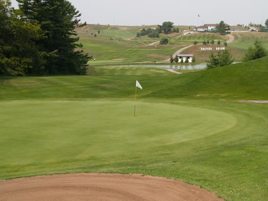 View of the eighth green from behind the trap