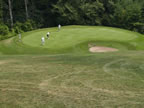 View down on the fifth green from in front of the Canadian flag (53kb)